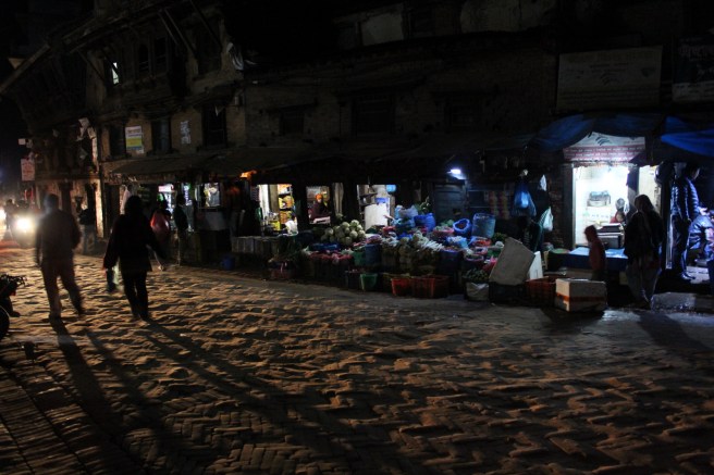 Those same storefronts by my guesthouse, by the light of darkness.
