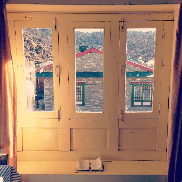 One of many romanticized writing spots, with that precious green notebook.